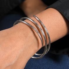 Molto's bestselling collection features a multi-spiral bangle that wraps around the wrist, highlighting your best feature. Light in weight, it can be paired with your watches and other bracelets, too. Made in sterling silver Available in size 7, 7.5, 8, and 8.5 inches Modern Stackable Bangle Bracelet, Modern Double Band Bracelet Strap Jewelry, Stackable Fusion Style Bangle Bracelets, Modern Spiral Jewelry For Formal Occasions, Modern Spiral Jewelry For Formal Events, Modern Spiral Bracelets For Gift, Slinky Bangle Jewelry As A Gift, Modern Spiral Bracelets As A Gift, Modern Flexible Bangle Jewelry