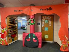 an entrance to a classroom decorated for christmas with decorations on the front and back doors