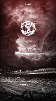 the manchester united logo is shown in this black and white photo with red clouds above it