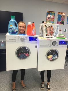 two women standing next to each other in front of washers with laundry products on them