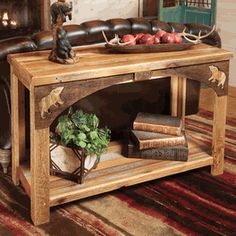 a wooden table topped with books and a bowl of fruit on top of it next to a fire place