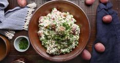 a bowl filled with potato salad next to other food items