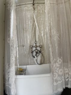 a white bath tub sitting under a bathroom window