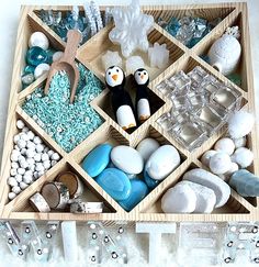 This Winter-themed loose parts sensory tray offers so many opportunities for open ended play, fine motor skills, and sensory play! It also makes a great gift, as it comes with all pieces packaged in small gift bags and secured in the tray with a ribbon!   This Winter loose parts sensory tray includes the following:  -10" square wooden tray with (13) sections -1 cup of colored rice with small snowflakes  -Colored chickpeas "snowballs" -6 oz "snow dough"  -2 hand-painted Penguin pegs  -4 hand-pour Loose Parts Winter Activities, Arctic Sensory Bin, Sensory Playdough, Painted Penguin, Tinker Tray, Small Snowflakes, Winter Sensory Bin, Dramatic Play Themes, Toddler Sensory Bins