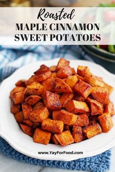 roasted maple cinnamon sweet potatoes on a white plate with a blue towel in the background