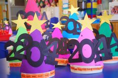 paper cups with numbers and stars on them for new year's eve party decorations