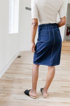 With the look of real denim but the feel of a quality knit, comfort is the key element in our exclusively designed 'Piper 'Skirt. The quick, pull on style with a fabric covered waistband makes this skirt a practical everyday option! Soft, comfortable knit denim fabric Functional Back Pockets 70% Rayon 25% Polyester 5% Spandex Wash Cold Gentle Cycle Hang to Dry Fabric covered elastic waistband Model A Height in Dark Blue 5'5" | Wearing Size Small Wearing 'Finch' Smocked Yoke Cotton Gingham Top in Gingham Top, Knit Denim, Gingham Tops, Knit Skirt, Main Street, Denim Fabric, Fabric Covered, Soft Knits, Chambray