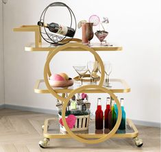 a bar cart with drinks and glasses on it