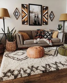 a living room filled with lots of furniture and pictures on the wall above it's couch