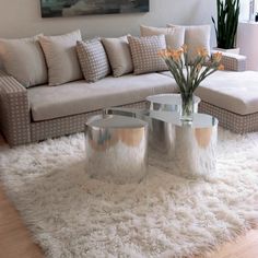 a living room filled with furniture and a white rug