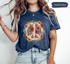 OxbridgeCo Floral Peace Shirt, Peace TShirt, Peace T-Shirt, Peace Sign Shirt, Peace Symbol Shirt, Boho Shirt, Hippie Shirt, Nature Lover Shirt This customized gift can be used by all the members of family, it will be the best wanderlust, travel apparel unisex personalized shirt ever! 👉 Product Details:The T-Shirts, Hoodies, Youth, Toddler and Baby Suits(onesie) are unisex.👈 👉Reading the Sizing Chart: Please note that the sizing chart includes the measurements of one side of the shirt, not the circumference. 👈 👉Please review all the sizing charts that were added in the product pictures. 👉How Do I Order👈 1️⃣ Please review all the information provided before placing an order 2️⃣ Select the shirt type and size using the drop down menu. 3️⃣ Select the color of the shirt using the followi Summer Crew Neck Top With Peace Sign, Cotton Peace Sign Short Sleeve T-shirt, Cotton Short Sleeve T-shirt With Peace Sign, Casual Peace Sign Summer Top, Casual Cotton T-shirt With Peace Sign, Casual Short Sleeve Tops With Peace Sign, Peace Sign Shirt, Peace Sign Shirts, Travel Apparel