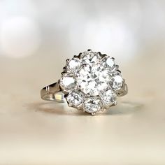 an antique diamond ring sits on a table