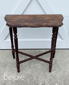 an old wooden table is sitting in front of a garage door with the words before painted on it