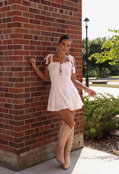 Step out in sweet southern charm with our Southern Sweetie Dress. Made with soft, breathable cotton and featuring a charming lace-up detail, this mini dress is the perfect blend of cute and comfortable. Pair with our Bronco Cowgirl Boots and this dress will have you feeling like a true southern belle. Fabric 100% cotton Lining 100% rayon White Dress And Cowgirl Boots, Southern Belle Aesthetic Outfits, Southern Belle Aesthetic, Southern Belle Outfit, Dress And Cowgirl Boots, Southern Belle, Southern Charm, Senior Year, New Tops