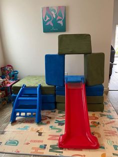 children's play area with colorful plastic chairs and slide in the middle, on carpeted floor