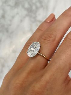 a woman's hand with a diamond ring on it