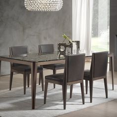 a dining room table with chairs and a chandelier