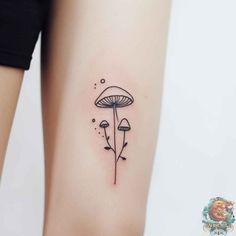 a small mushroom tattoo on the right side of the leg, it is black and white