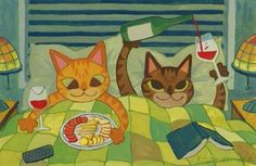 two cats laying in bed with food and wine