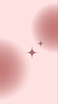 two black circles on a pink background with some light coming from the top and bottom