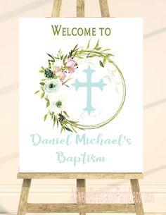 a welcome sign with flowers and a cross in the center is shown on an easel