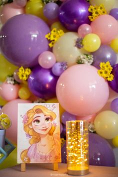 a table topped with balloons and a card