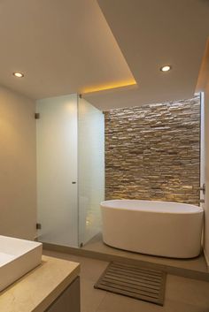 a bathroom with a large white tub next to a walk in shower