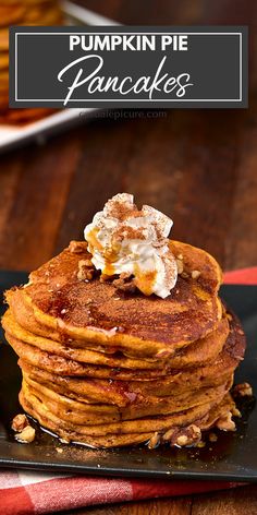 pumpkin pie pancakes on a black plate with whipped cream and pecans in the background