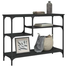 a black shelf with two baskets and pictures on it