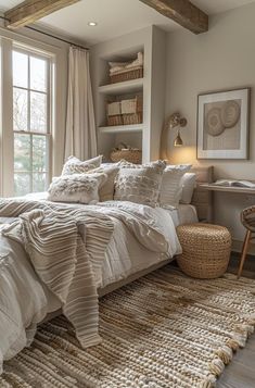 a bedroom with a large bed and lots of white linens on the covers, pillows and blankets