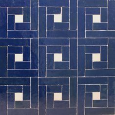 a blue and white tiled wall with squares in the middle, on top of each other