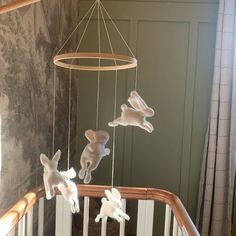 a baby crib with stuffed animals hanging from it