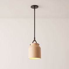 a light fixture hanging from the ceiling in a room with white walls and flooring