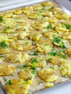 an uncooked casserole with potatoes and parsley