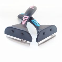 two black and pink combs sitting on top of each other