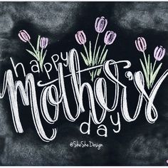 the words happy mother's day written in chalk on a blackboard with pink and purple tulips