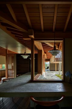 the interior of a house with wood and stone accents, as seen through an open window