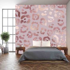 a bedroom with pink wallpaper and leopard print on the walls, along with a chevron wood floor