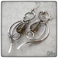 a pair of earrings with wire wrapped around them