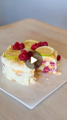 a piece of cake with raspberries and lemon slices