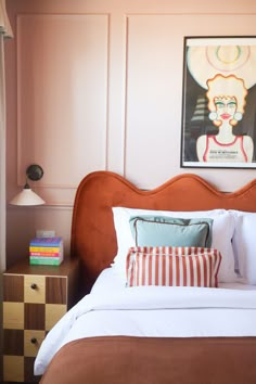 a bedroom with a bed, nightstand and painting on the wall