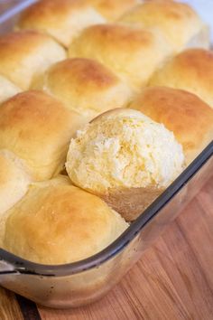 a baking dish with rolls in it on a wooden table