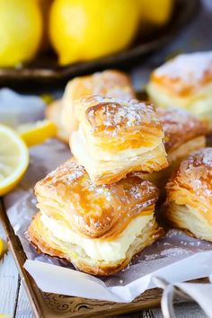 lemon filled pastries are stacked on top of each other in front of some lemons