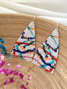 These abstract seed bead earrings with colorful stripes are made from selected Czech beads. It can be an excellent personalized gift for bridesmaids, Mothers Day, birthdays, Valentine's Day, Wedding day, Christmas, New Year, and for your loved ones. ♡ Bead Length - 2.7'' (7 Centimeters) ♡ Total Length - 3.1'' (8 Centimeters) ♡ Width - 1.6'' (4 Centimeters) ♡ Quality Czech beads ♡ Stainless steel mounts If you like these fringe beaded earrings but would like them in a different color please email Handmade White Heishi Beads Earrings, Handmade Multicolor Heishi Beads Earrings, Heishi Beads Earrings For Gifts, Multicolor Heishi Beads Earrings With Ear Wire, Multicolor Heishi Beads Dangle Earrings, Bohemian Multicolor Heishi Beads Earrings, Gift Heishi Bead Earrings, Colorful Heishi Bead Earrings For Gifts, Colorful Heishi Beads Earrings As Gift