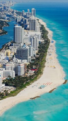 an aerial view of the beach and city skyline in miami, with skyscrapers on either side