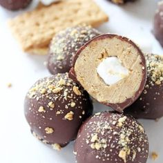 chocolate covered donuts and crackers on a white surface