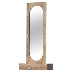 a mirror sitting on top of a wooden stand