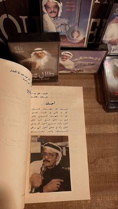 an open book with pictures and letters on the pages is shown next to other books