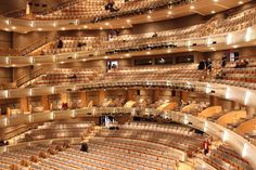 an auditorium filled with lots of seats and people