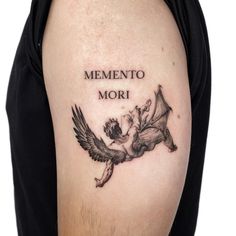 a woman with a tattoo on her arm that says, mementoo mori